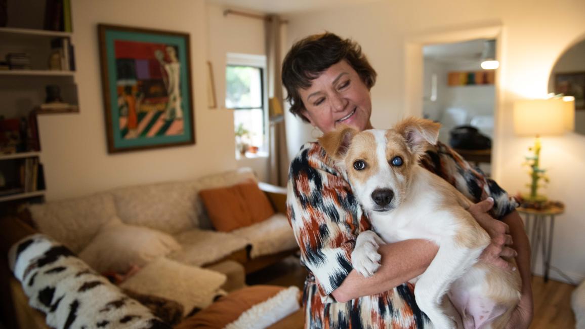 Karen holding Halo the puppy in a home