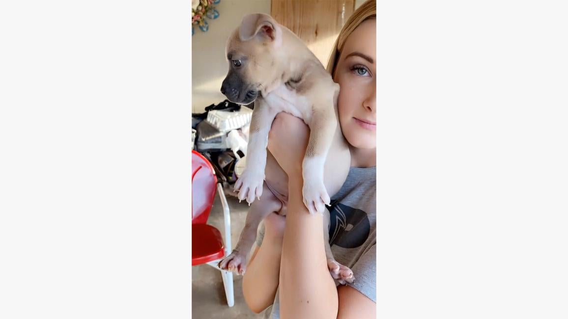 Skylar Clark holding Grunt the puppy