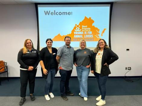 Virginia Is for Animal Lovers Shelter Summit team in front of a welcome slide on the wall