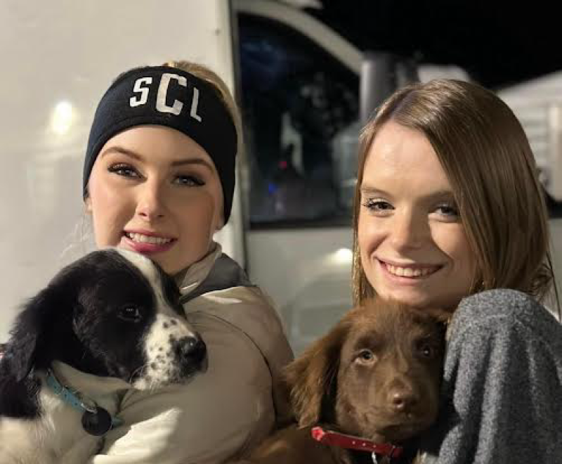 Skylar Clark and her sister Halee loading puppies for a transport